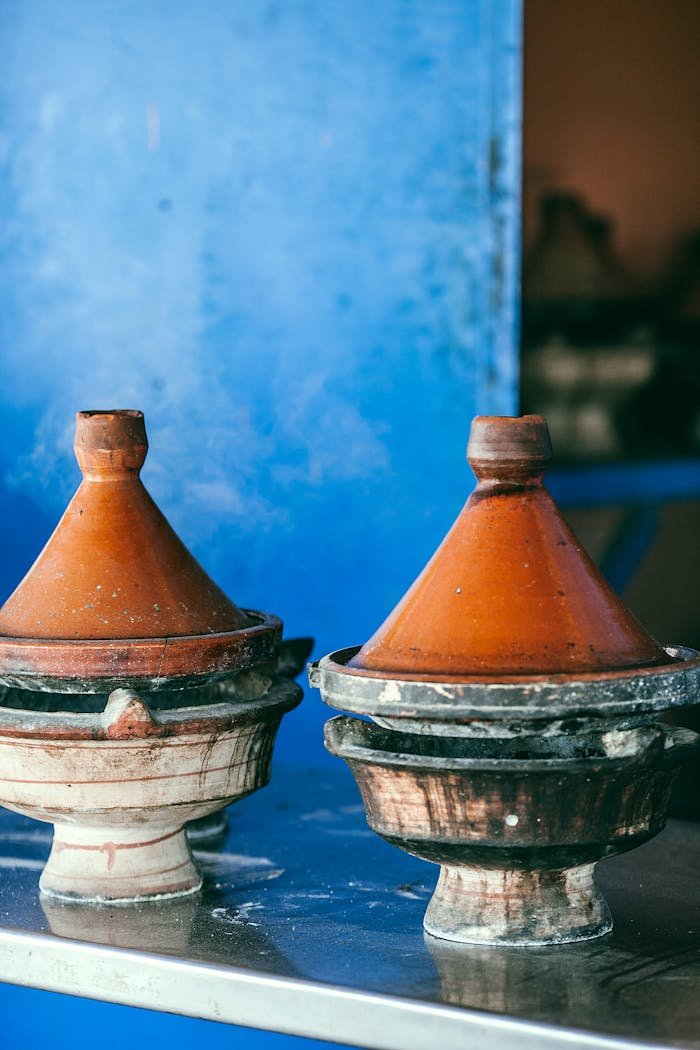 about-01 Traditional Moroccan heat resistant tajines with cone shaped covers and circular base on table